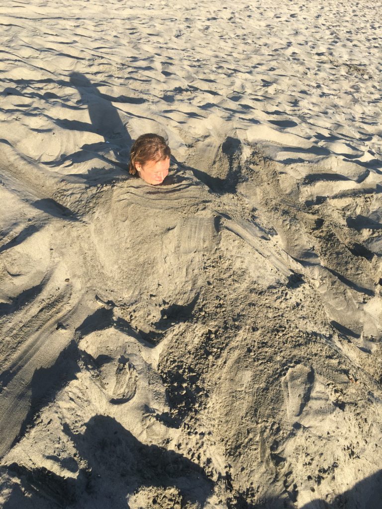 macy asked to be buried in the sand. What is it about this that's so cool!? lol